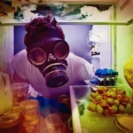 a man in a gas mask because the refrigerator smells bad